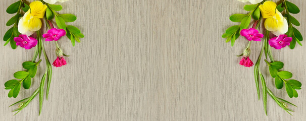 Pattern of phlox and violets on a beautiful gray background. Wide photo.