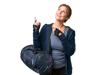 Middle-aged sport woman with sport bag over isolated background pointing with the index finger a great idea