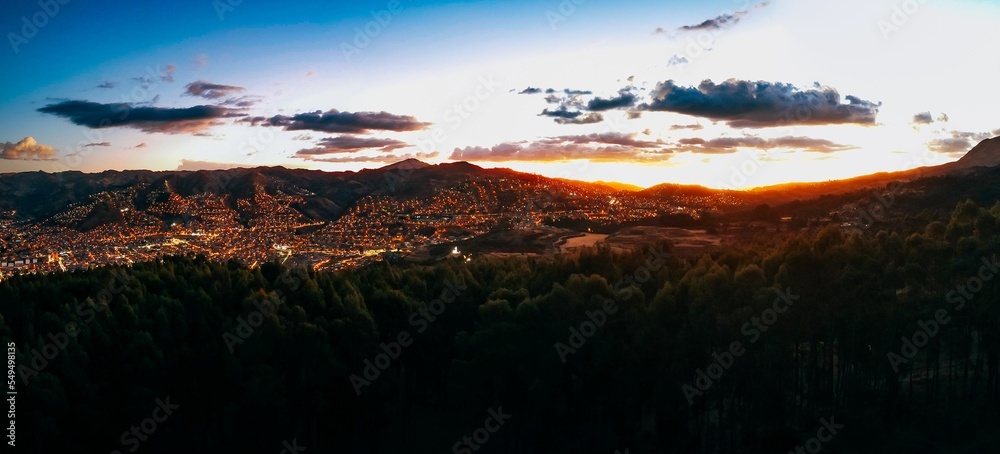 Wall mural Panoramic view of a beautiful sunset over the Cusco city, Peru