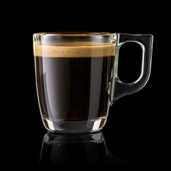 Glass cup of espresso coffee isolated on black.