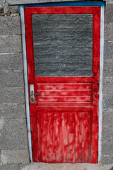 Red door, old weathered iron door painted red.