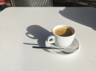 Coffee cup over terrace table a sunny day