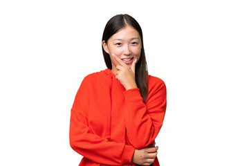 Young Asian woman over isolated background holding copyspace imaginary on the palm to insert an ad