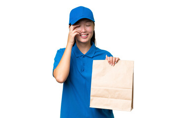 Young Asian woman taking a bag of takeaway food over isolated background laughing