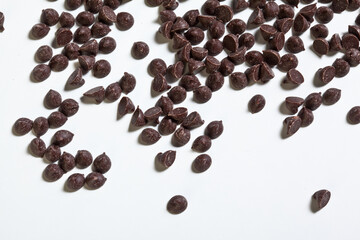 Row of chocolate chips on white background