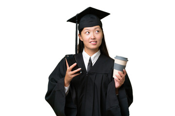 Young university graduate Asian woman over isolated background holding coffee to take away and a mobile while thinking something