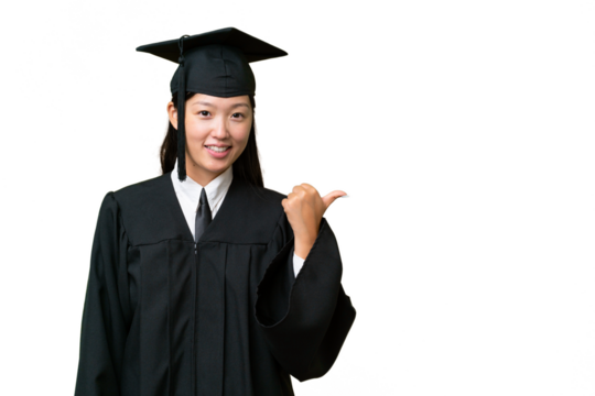 Young university graduate Asian woman over isolated background pointing to the side to present a product