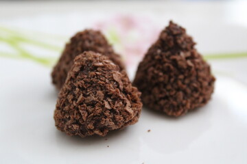 close up of chocolate truffles on a plate