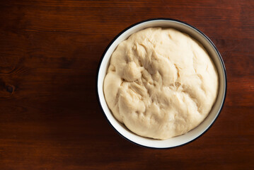 Process of raising the dough in a special basket. Dough made from natural sourdough. Wheat dough. Fermentation. Top view.	