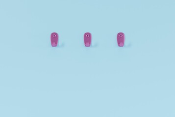 Hangers on a blue wall. Minimalist concept, hanging towels, clothes on hangers. 3D render, 3D illustration.