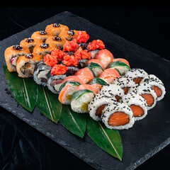 Set of japanese sushi rolls with tuna, sea bass, salmon, cream cheese, rice paper, shrimp and sweet pepper.