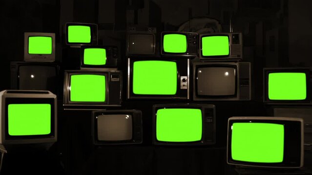 Pile of Vintage Televisions Arranged One on Top of Another Turning On Green Screens. Sepia Tone. 4K Resolution.
