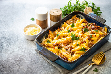 Pasta penne with minced meat, cheese and creamy sauce. Mac and cheese. Baked dish.
