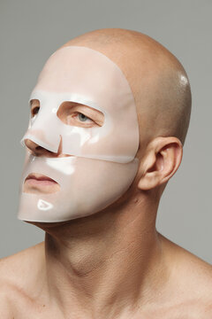 Beauty portrait of unrecognizable man with hydrogel collagen mask applied on his face
