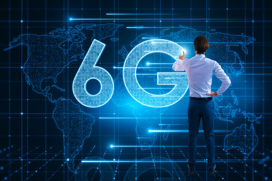 Back view of young man using glowing 6G hologram with map on blurry background. Wireless internet and web speed concept.