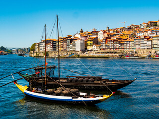 Incredible view of Porto, with its coloured houses and typical boats on the banks of Douro river, Portugal
