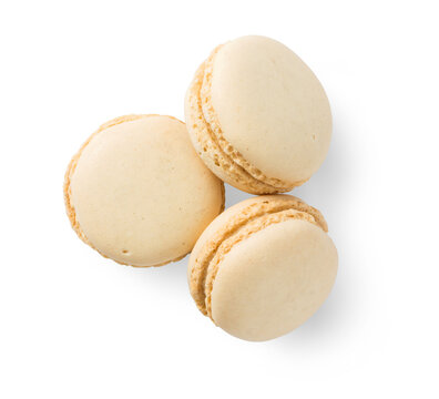 group of three delicious French vanilla macaroons, sweet isolated design element, top view / flat lay