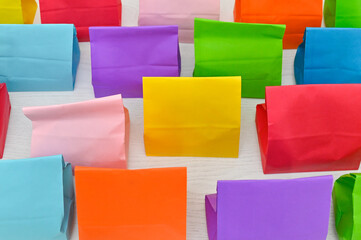 Set of colorful shopping folded paper bags on white background. Paper shopping bags mockup, blank...