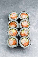 Set of sushi rolls with salmon fish, fried shrimp, rice, cucumber and nori.