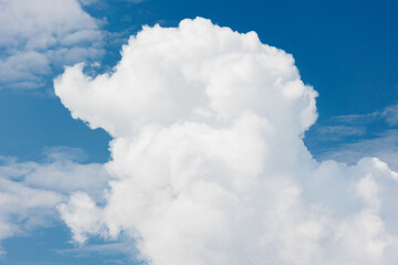 Naklejka na ściany i meble white cumulus clouds against a blue sky, beautiful large thunderclouds in the sky. background of nature. freedom and flight above the earth among the clouds, a dream and a desire. place for