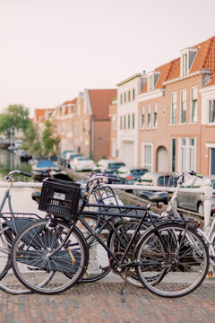 A typical picture from a small Dutch town: Several bicycles are leaning against a bridge over a small river.