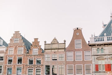 Magnificent old rooftops of different kinds in a small Dutch town. The sky is cloudy and summer is in the air.