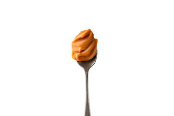 Liquid melted caramel syrup, paste on a spoon isolated on a white background. Curl, wave of caramel.