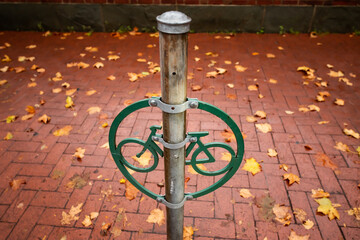 Bike parking pole on a brick sidewalk in the historic part of downtown Philadelphia, Pennsylvania on a rainy autumn day