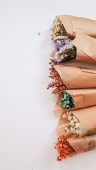 Small bouquets of flowers with lavender, limonium, dried flowers, wrapped in kraft paper, a nice little gift