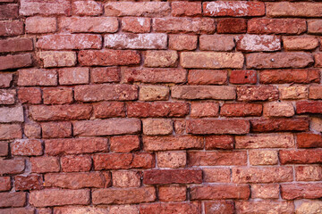 Fototapeta premium Urban background. Detail of an old red brick wall.