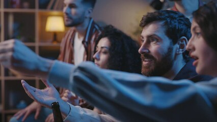 Football fans discussing championship while sitting at home in living room on couch and watching competition on TV. People supporting favorite team and waiting for a goal.