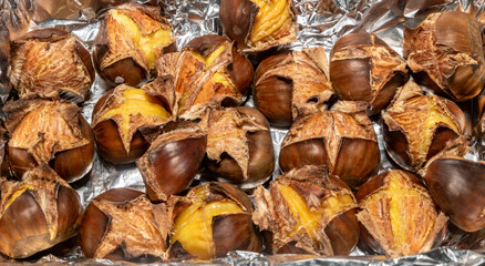Portuguese chestnut (Castanea sativa) roasted in selective focus and closeup. Christmas nuts in fine details