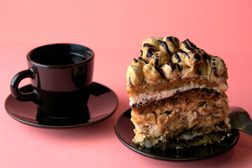 A piece of cake on a plate and coffee