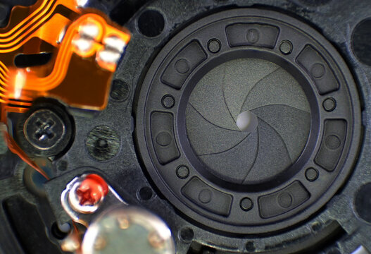 Objective aperture blades mechanism, camera lens aperture and electronic connection close up macro with sharpness gradient	
