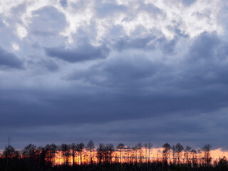 Cloudy afternoon over a lake. Epic clouds on sunset.