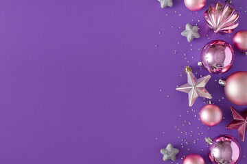 Christmas Day decorations concept. Top view photo of pink baubles, stars and sequins on violet background with copy space. Creative holiday card idea.