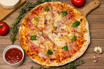 Freshly baked pizza with ham, tomato, and cheese