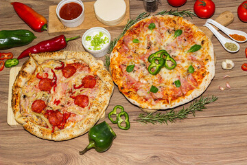 Pepperoni pizza and pizza Capricciosa with mozzarella cheese, ham, tomato sauce, salami, mushroom, pepper, spices and fresh basil