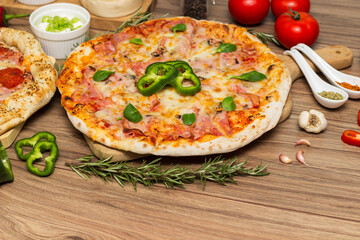 Pepperoni pizza and pizza Capricciosa with mozzarella cheese, ham, tomato sauce, salami, mushroom, pepper, spices and fresh basil