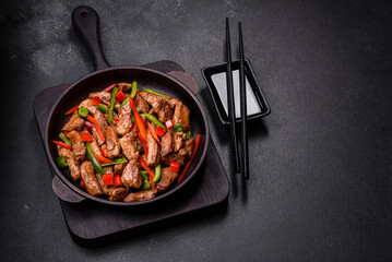 Delicious Asian teriyaki meat with red and green bell peppers