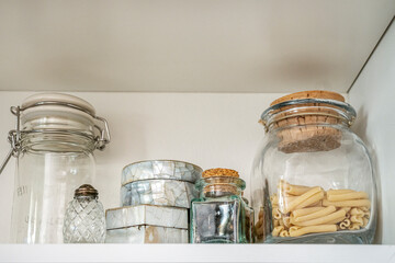 A shelf full of glass jars and others made of old mother-of-pearl