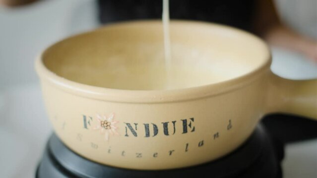 Swiss  Cheese Fondue  stirring bread