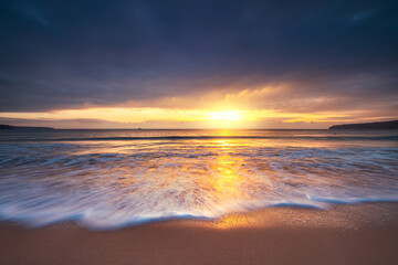 Beautiful sunrise over the sea and beach