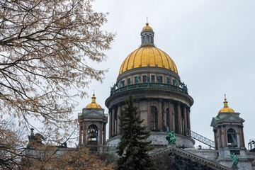 Bottom-up view of the golden domes of the cathedral. Saint Isaac Cathedral in the city of St. Petersburg, Russia. Architectural historical landmark of Saint Petersburg. Popular tourist attraction.