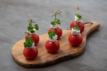 Cherry tomatoes, tomatoes and herbs. Tomatoes and feta cheese. Christmas photo idea. 