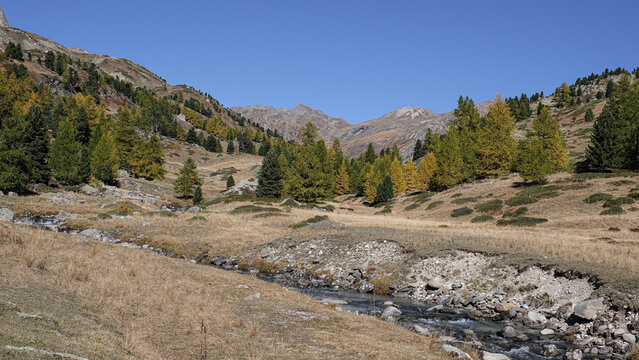 View of the scenic Valee de la Claree in the French Alps with Massif de Cerces mountains on either side of the valley, near Briancon, France