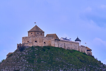 Fototapeta na wymiar Sümeg castle at the top of the hill against blue cloudy sky