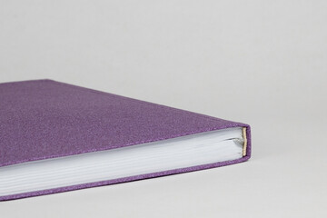 Close up of top of purple cover diary isolated on white background