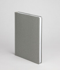  A gray diary in a standing view on a table on a white background
