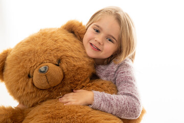 Adorable little girl with red teddy bear